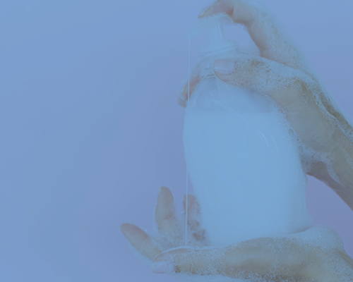 hand pushing soap dispenser on other hand