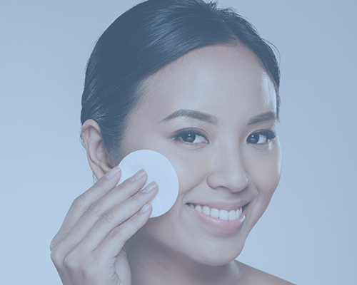 woman applying makeup remover with a pad