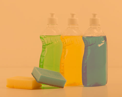 three bottles of dish soap and to sponges